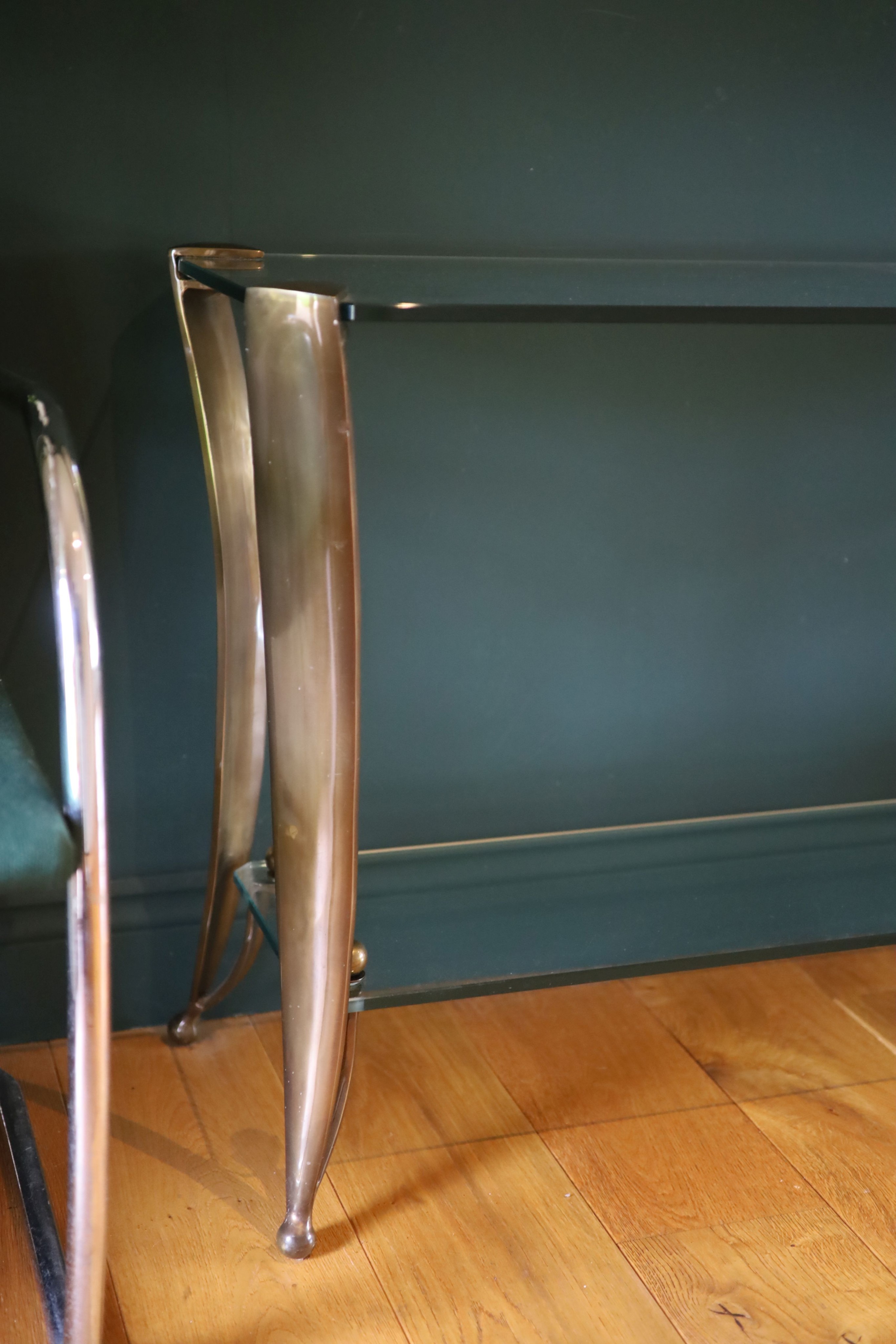 An Art Deco style bronze and glass two tier console table, width 153cm depth 44cm height 73cm